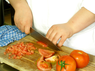 Chef is dicing tomatoes